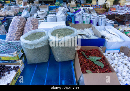 Uno stallo in un mercato di strada fine settimana a Cefalú, Sicilia, Italia che vende erbe, leges.dried pesce, noci ecc Foto Stock