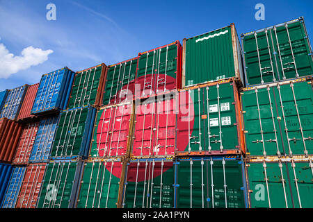 La bandiera nazionale del Bangladesh su un numero elevato di contenitori in metallo per lo stoccaggio di merci accatastate in righe sulla parte superiore di ogni altro. Il concepimento di storage Dell Foto Stock