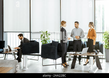 Coppia giovane risolvere alcuni finanziario o di problemi legali con consulenti aziendali presso l'hotel di lusso bank office Foto Stock