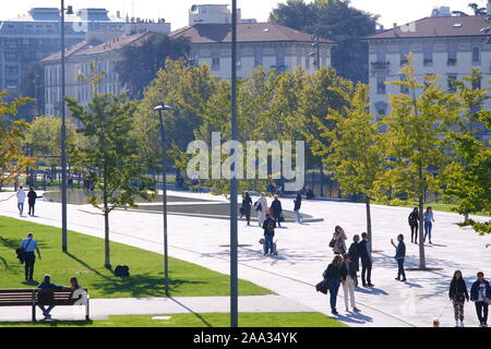 Citylife a Milano, Lombardia, Italia. Circa il 10/2019. CityLife Milano complesso residenziale. Persone passeggiare nel verde di giardini con alberi. Foto Stock