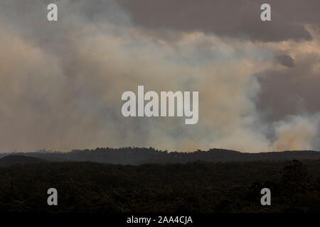 Fire Fighting elicotteri volare in fumo durante un incendio di bush nelle Blue Mountains in Australia Foto Stock