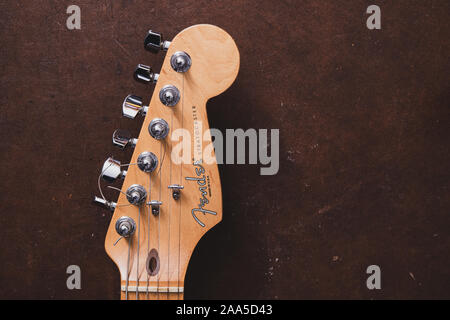 Roma, 17 novembre 2019. Elevato angolo di visione da vicino il concetto di musica di chitarra elettrica Fender stratocaster testa e piroli vintage in vecchio stile Foto Stock