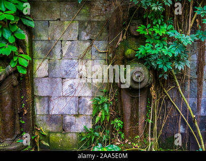 Femmina scultura spirituale tenendo un vaso con versando acqua, bellissimo giardino fondo di architettura Foto Stock