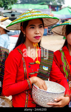 Un giovane minoranza etnica donna attende l elemosina ai monaci che stanno prendendo parte a una processione, la grotta di Pindaya Festival, Pindaya, Stato Shan, Myanmar Foto Stock