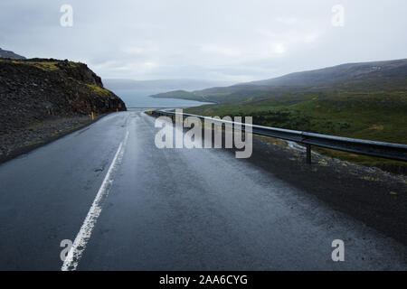 Un vuoto strada islandese diretti verso il mare. Foto Stock