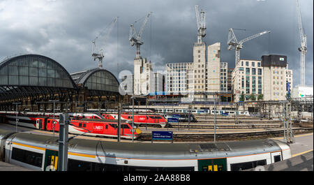 London, England, Regno Unito - 2 Agosto 2019: LNER e treni Thameslink attendere presso le piattaforme a Londra la stazione di King Cross mentre gru a torre in piedi sopra Foto Stock