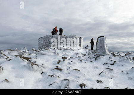 Walkers sul Vertice di Scafell Pike in inverno, Lake District, Cumbria, Regno Unito Foto Stock