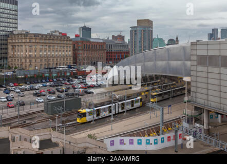Manchester Metrolink tram lasciando Manchester Victoria in direzione est con lo skyline della città dietro Foto Stock