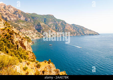 Splendido scenario paesaggistico di Positano, Italia. Costa rocciosa pieno di barche e yacht che viaggiano nei pressi di alta montagna. Paesaggio di Positano susseguono Foto Stock