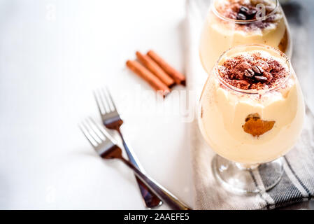 Tiramisù tradizionale dessert italiano in un bicchiere su sfondo bianco Foto Stock