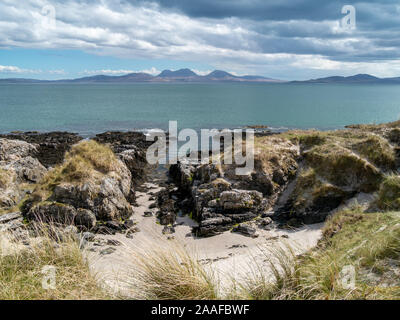 Una vista in lontananza l'Isle of Jura con le pappe del Giura all'orizzonte come si vede dall'Isola di Colonsay, Scotland, Regno Unito Foto Stock
