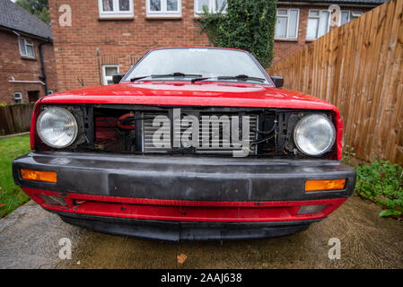 Classico Volkswagen Golf GTI rosso: Car crash i danni e i dettagli da vicino. Schiacciato il metallo e la plastica. Paraurti anteriore dei danni dopo un incidente stradale. Foto Stock