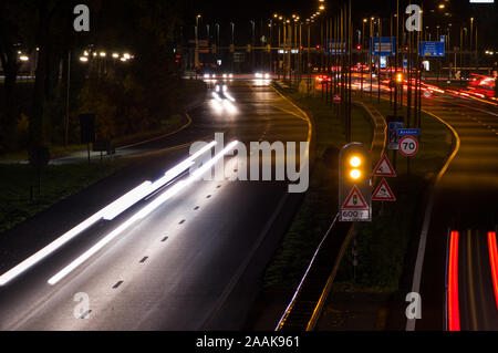 Intersezione di notte con semafori e traffico offuscata dal movimento in Arnhem, Paesi Bassi Foto Stock