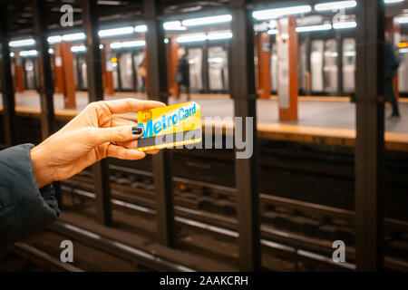 Donna che mantiene una MetroCard a New York City. Foto Stock