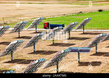 Un carrello passa fotovoltaiche pannelli nella parte di Solucar complesso solare di proprietà di Abengoa energia, a Sanlucar La Mayor, Andalusia. Foto Stock