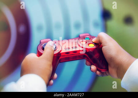Un bambino che gioca un genere di ripresa video gioco, close-up di mani tenendo il controller e premendo i pulsanti. Foto Stock