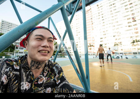 Un giovane uomo cinese al di fuori degli appartamenti in Choi Hung Estate in Hong Kong Foto Stock