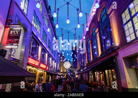 LONDON, Regno Unito - 24 NOV 2019: Ganton Street a Londra durante il periodo natalizio. La gente può essere visto. Foto Stock