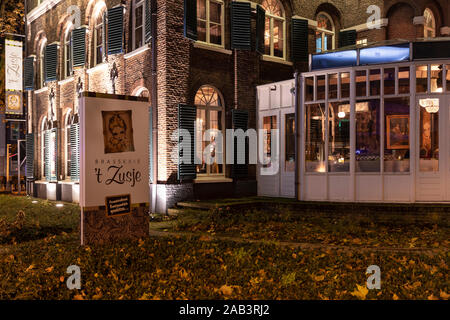 Eindhoven, Paesi Bassi, 7 novembre 2019. Ristorante het zusje di notte con diversi golden luci colorate e un conservatorio, circondato da tr Foto Stock