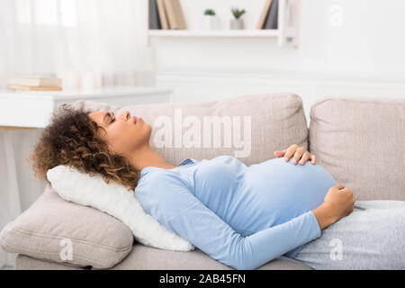 African-american donna incinta che soffrono di dolore addominale Foto Stock