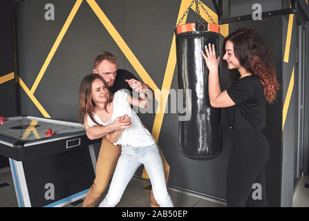 Ritratto di divertente Boxer vestiti in jeans e magliette in un centro di giochi per computer. Foto Stock