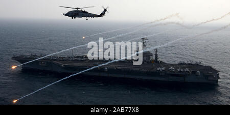 (Feb. 15, 2013) un MH-60R Sea Hawk da rapaci di elicottero Maritime Strike Squadron (HSM) 71 lancia razzi a fianco della portaerei USS John C. Stennis (CVN 74). Foto Stock