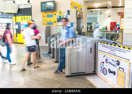 Asia/Singapore - Nov 22, 2019 : i passeggeri di entrare e uscire dal gantry. MRT è un pesante sistema ferroviario che costituisce la maggior parte delle zone urbane, suburbane rapida Foto Stock