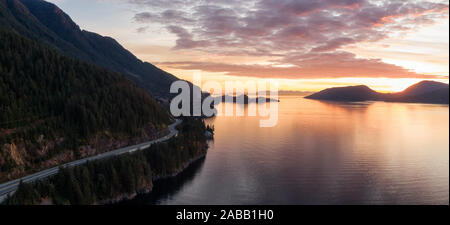 Sea to Sky Hwy in Howe Sound vicino a baia a ferro di cavallo, West Vancouver, British Columbia, Canada. Antenna vista panoramica durante un tramonto colorato nella caduta dei mari Foto Stock