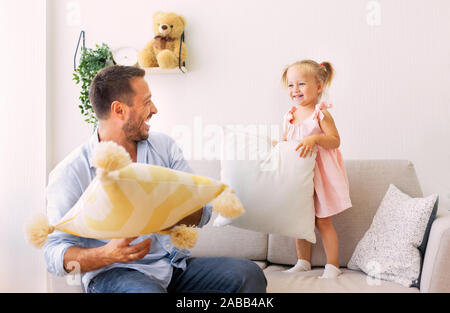 Giocoso famiglia avente un cuscino lottare insieme Foto Stock