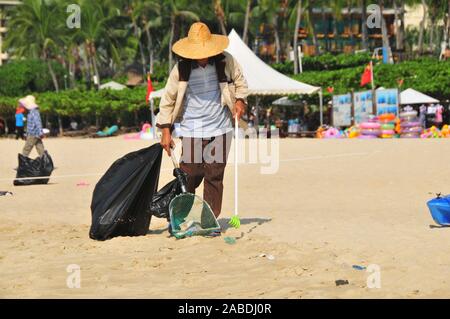 Una persona che preleva i rifiuti lasciati dai turisti vicino alla spiaggia di Yalong Bay di Sanya city, a sud della Cina di Hainan provincia, 4 ottobre 2019. Foto Stock