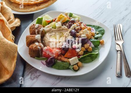 Caricata insalata greca hummus falafel piastra con pane pita Foto Stock