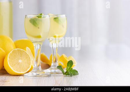 Alcool bere cocktail con limone, menta e ghiaccio in un piccolo bicchiere. Foto Stock