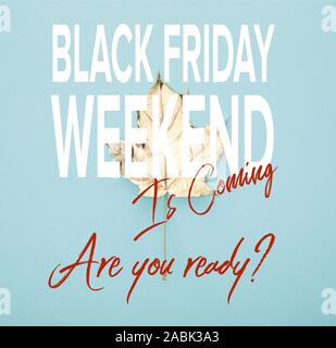 Vista superiore del golden autunnali maple leaf su sfondo blu con il Black Friday weekend illustrazione Foto Stock