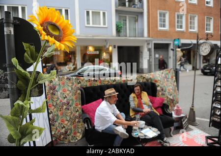 Sedersi e rilassarsi al bordo della strada a Park(ing) Giorno in Reichenbachstraße nel trimestre Gärtnerplatz. Con questa campagna, la città verde iniziativa ambientale vuole attirare l attenzione a come i numerosi spazi di parcheggio nella città può essere utilizzato come alternativa per la ricreazione e spazi verdi, ciclisti, ecc. La campagna è anche destinato a promuovere l uso della città molti parcheggi auto come un luogo per rilassarsi. [Traduzione automatizzata] Foto Stock