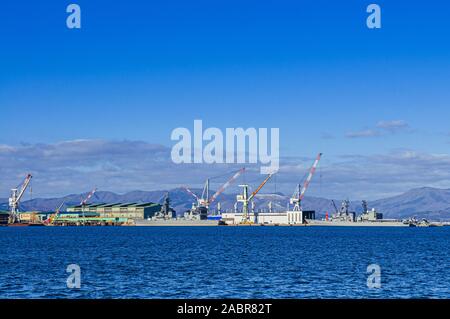 Dicembre 2, 2018 Hakodate, Giappone - Hakodate blu baia del porto e porto industriale con grandi gru e nave vista montagne sullo sfondo Foto Stock