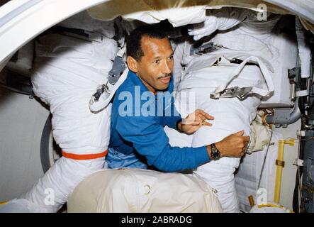 STS-31 pilota Charles F. Bolden, è circondato da extravehicular mobility spacesuits unità nella airlock della terra-orbiting space shuttle Discovery. I vestiti non utilizzati al di fuori del veicolo spaziale come la missione spacewalk è stata annullata. Foto Stock