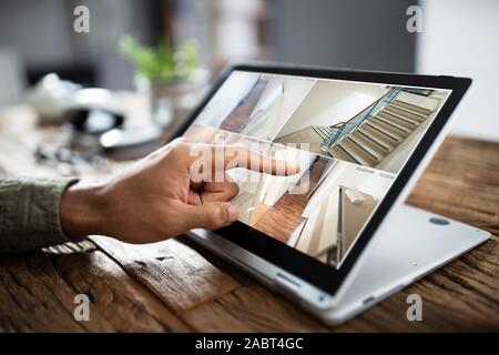 Close-up di un imprenditore il canto Controllo telecamera TVCC filmati sul computer portatile Foto Stock