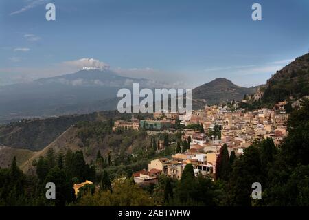 L'Italia, sicilia, Taormina, cittadina con l'Etna e la fuoriuscita di vapore dal cratere Foto Stock