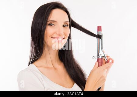 Asian giovane donna torsioni i suoi capelli curling su Foto Stock