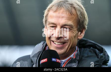 Berlino, Germania. 30 Novembre, 2019. Calcio: Bundesliga, Hertha BSC - Borussia Dortmund, XIII GIORNATA, Olympic Stadium. Berlin's head coach Jürgen Klinsmann parla sorridendo in una intervista prima di iniziare il gioco. Credito: Andreas Gora/dpa - NOTA IMPORTANTE: In conformità con i requisiti del DFL Deutsche Fußball Liga o la DFB Deutscher Fußball-Bund, è vietato utilizzare o hanno utilizzato fotografie scattate allo stadio e/o la partita in forma di sequenza di immagini e/o video-come sequenze di foto./dpa/Alamy Live News Foto Stock