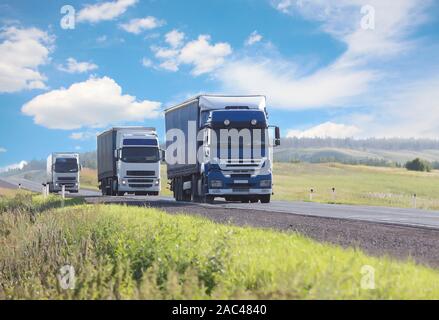 Escort di carrelli si muove sul paese autostrada Foto Stock