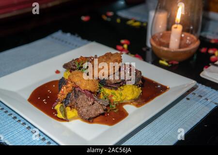 Bistecca di manzo servito con patate e cipolle in Goa, India Foto Stock