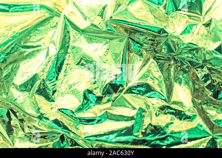 Luminose del Natale e del nuovo anno gold e menta sfondo. Shiny verde menta foil texture. Foto Stock