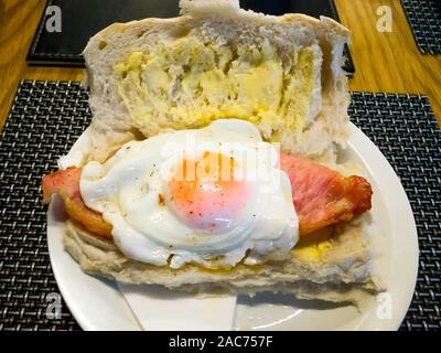 La colazione panino soffice Focaccia bianca con pancetta affumicata e le uova Foto Stock