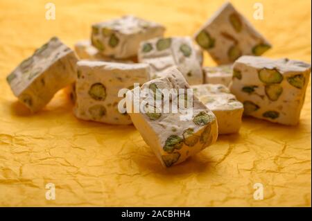 Orientale torrone arabo dolcezza con pistacchi su carta gialla sfondo. Close up Foto Stock