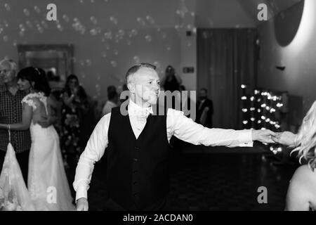 Le persone ballano e si divertono ad un ricevimento di nozze, dopo una festa al Manor Hotel and Guest House, Cheadle, struttura per matrimoni classificata di secondo livello Foto Stock