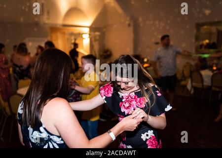 Le persone ballano e si divertono ad un ricevimento di nozze, dopo una festa al Manor Hotel and Guest House, Cheadle, struttura per matrimoni classificata di secondo livello Foto Stock