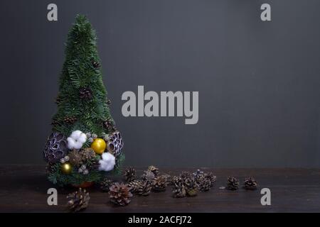 Albero di Natale fatto di rami di abete e decorate con materiali naturali e molti coni Foto Stock