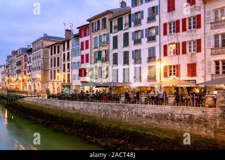 Bere e godere di una notte fuori lungo la riva del fiume Nive, Quai Galuperie, Bayonne, Pirenei Atlantiques, Paese Basco, Francia, Europa Foto Stock