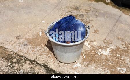 Pila di biancheria sporca in un cestello di lavaggio, il cestello con i vestiti puliti Foto Stock